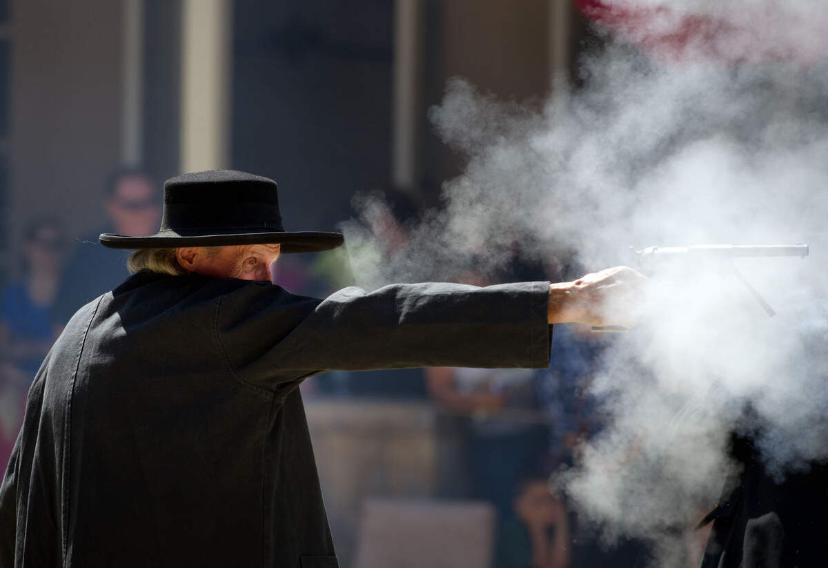 Don Woolcott, playing the part of Sacramento's first sheriff James McKinney, fires his handgun during a 2011 re-enactment of the Squatter's Riot of 1850.